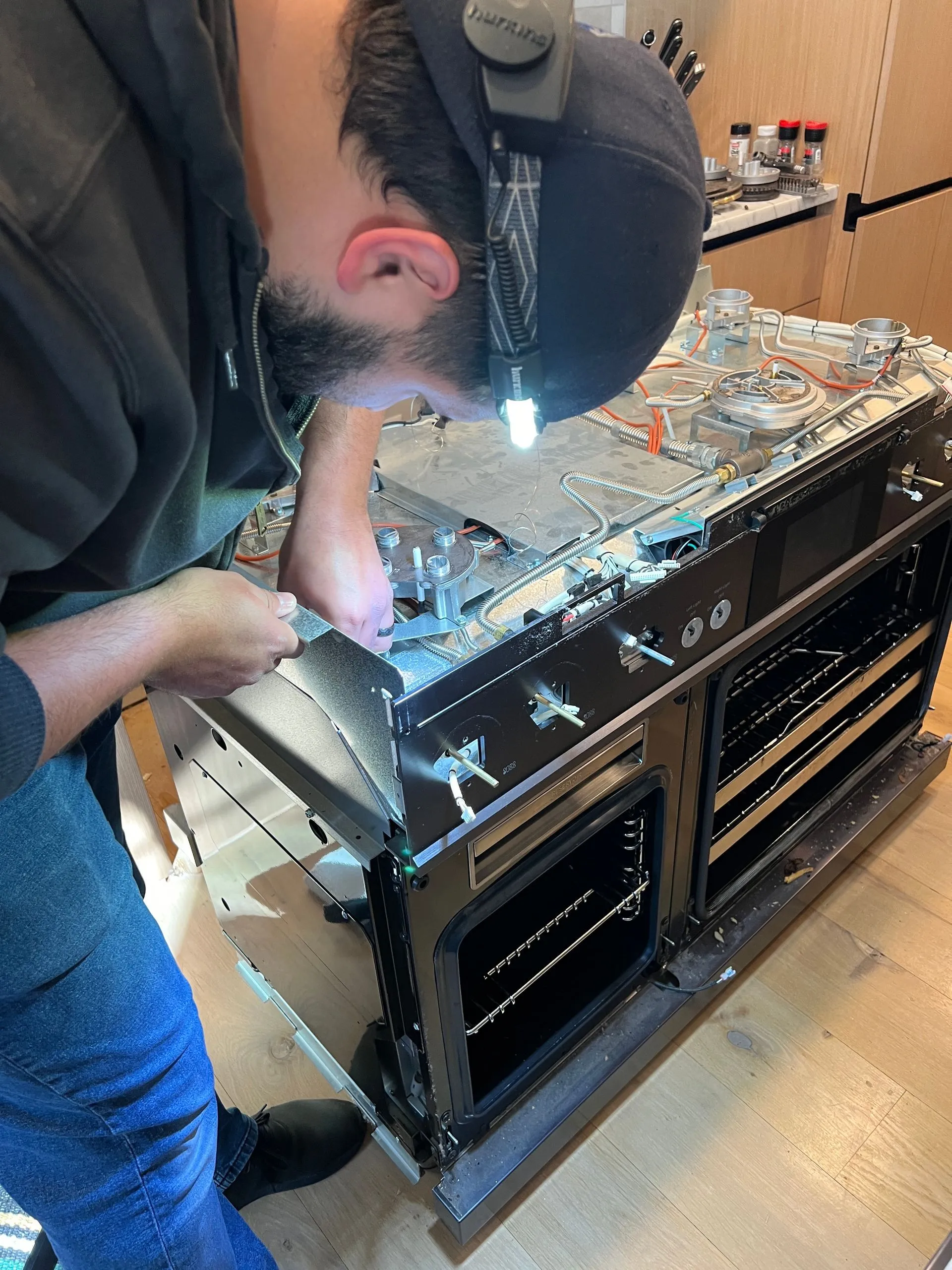 Technician repairing a commercial-grade range
